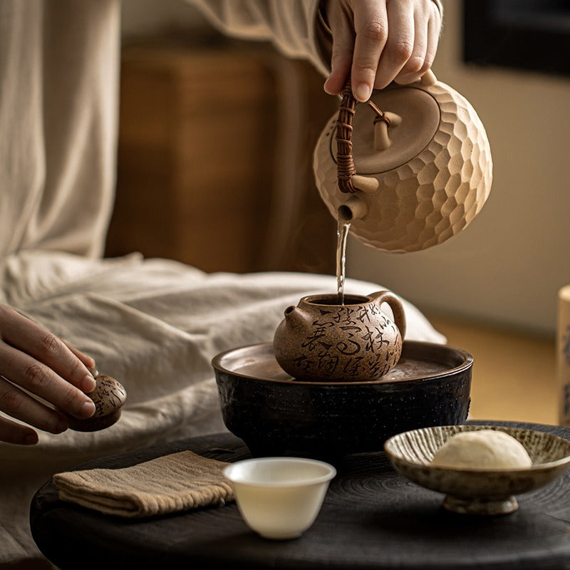 Close-up of a heatable clay teapot for loose leaf tea in a cozy setting