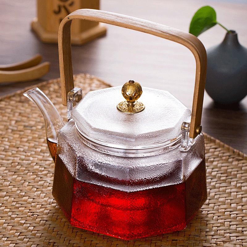 Close-up of heat resistant glass teapot with loose leaf tea.