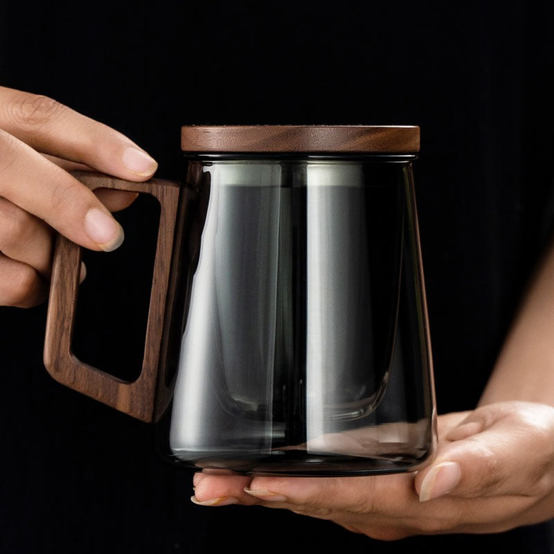 Office setting with a stylish eco-friendly glass tea cup with infuser on a desk