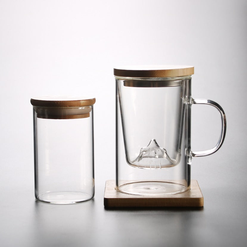 Elegant borosilicate glass tea cup with mountain infuser, perfect for brewing.