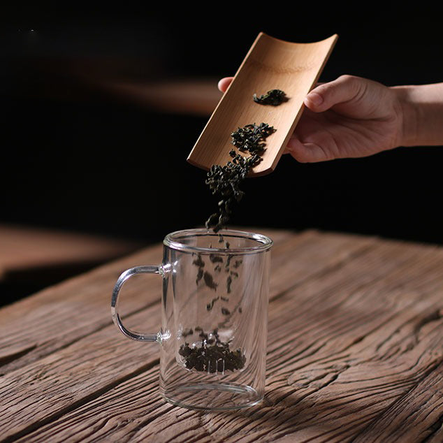 Close-up of the glass teacup displaying its artistic design and functionality.