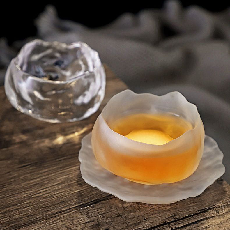 Side profile of the borosilicate glass cup filled with herbal tea on wood — perfect for gifting.