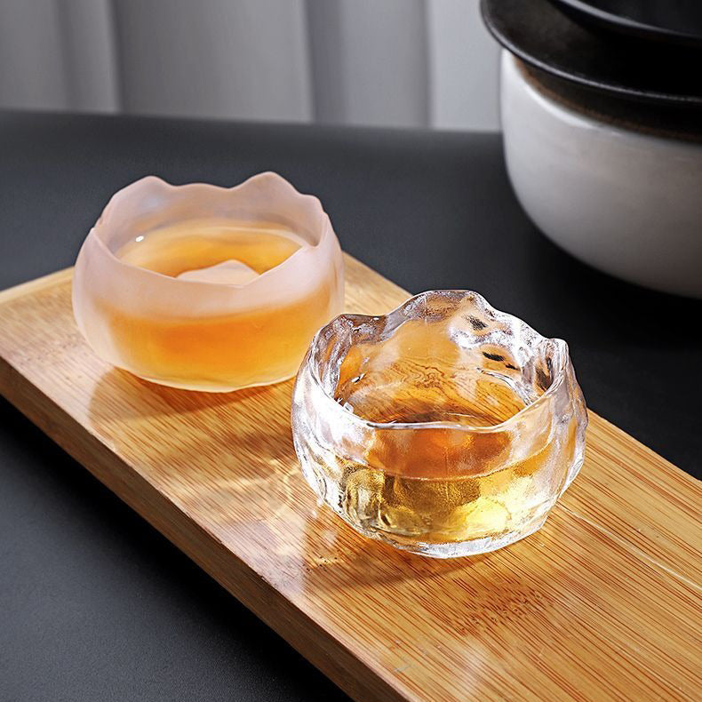 Overhead view of the tea cup with saucer highlighting the glass mug’s artistic ice-block design.