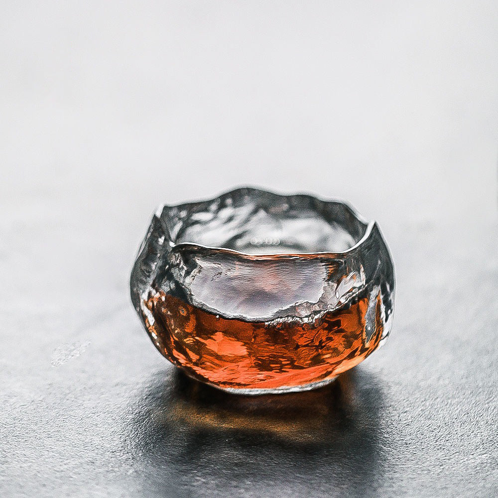 Overhead view of the tea cup with saucer highlighting the glass mug’s artistic ice-block design.