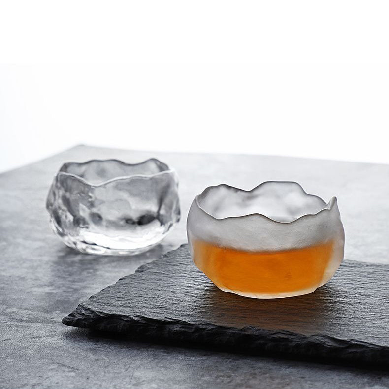 Side profile of the borosilicate glass cup filled with herbal tea on wood — perfect for gifting.