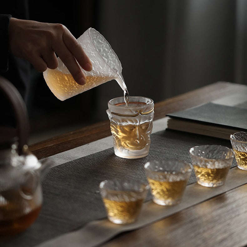 Close-up of the glass tea cup filled with freshly brewed tea, highlighting its artistic value.