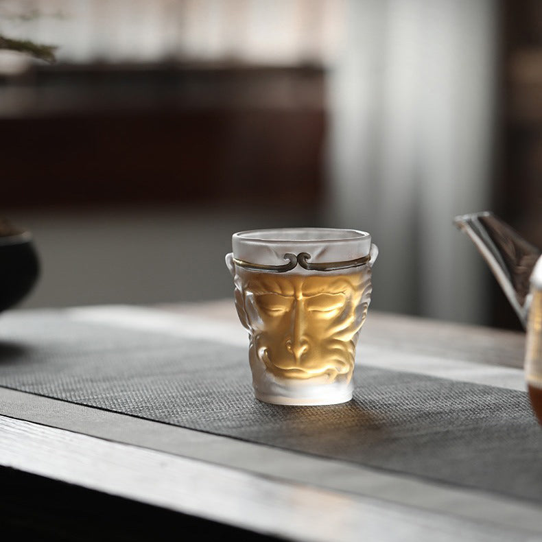 Close-up of the glass tea cup filled with freshly brewed tea, highlighting its artistic value.