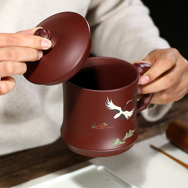 Top-down view of the purple clay teacup with crane and pine design, showcasing traditional chinese tea ware craftsmanship