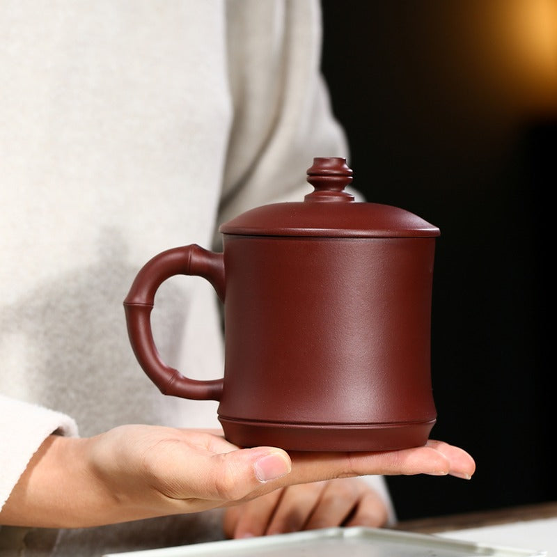 Side profile highlighting the bamboo-shaped handle and textured purple clay teacup surface
