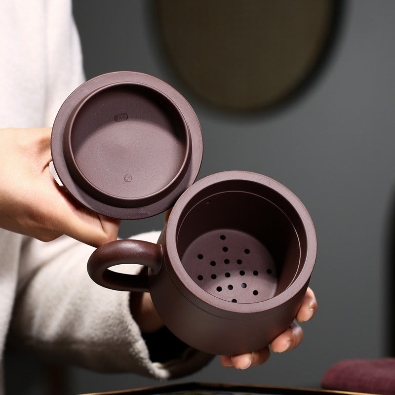 Yixing purple clay tea cup with infuser for meditation and loose tea brewing