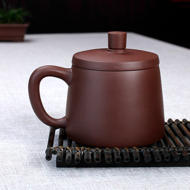 Tea preparation scene with Yixing clay teacup and infuser