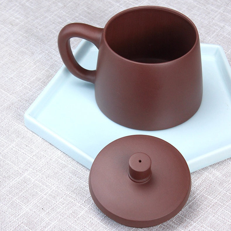 Side view of purple clay tea mug with infuser for loose leaf tea