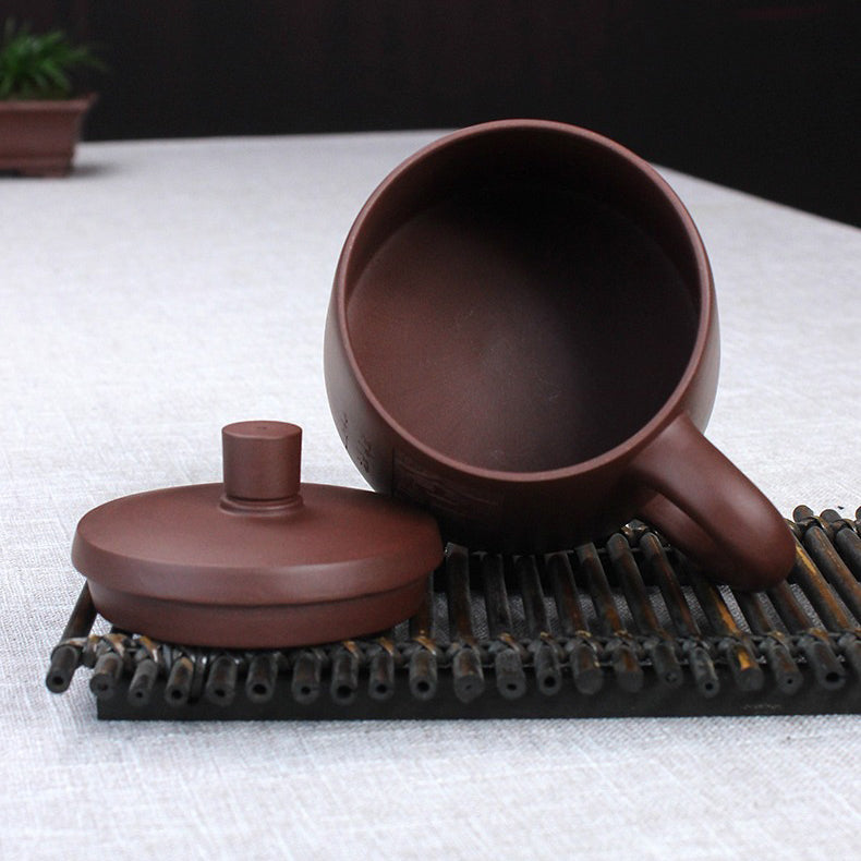 Tea preparation scene with Yixing clay teacup and infuser