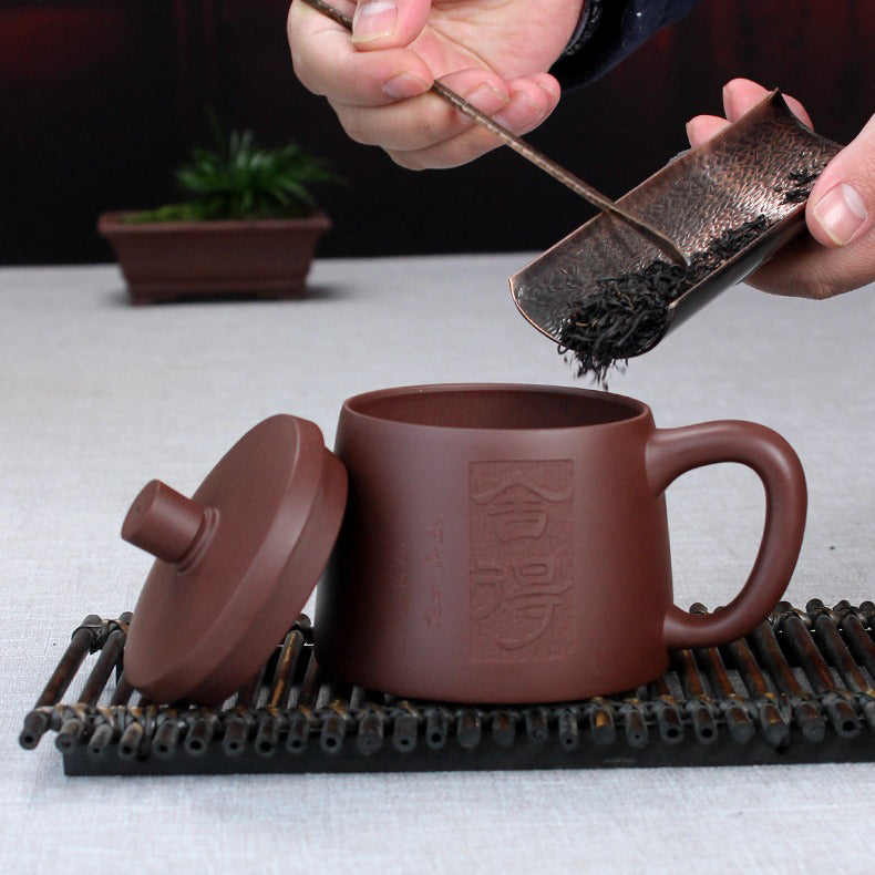 Side view of purple clay tea mug with infuser for loose leaf tea