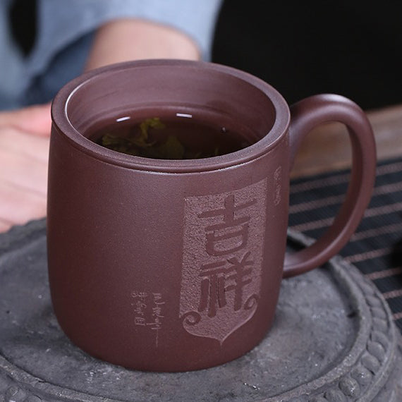 Close-up of the purple clay lion tea cup with infuser, highlighting the lion lid and craftsmanship