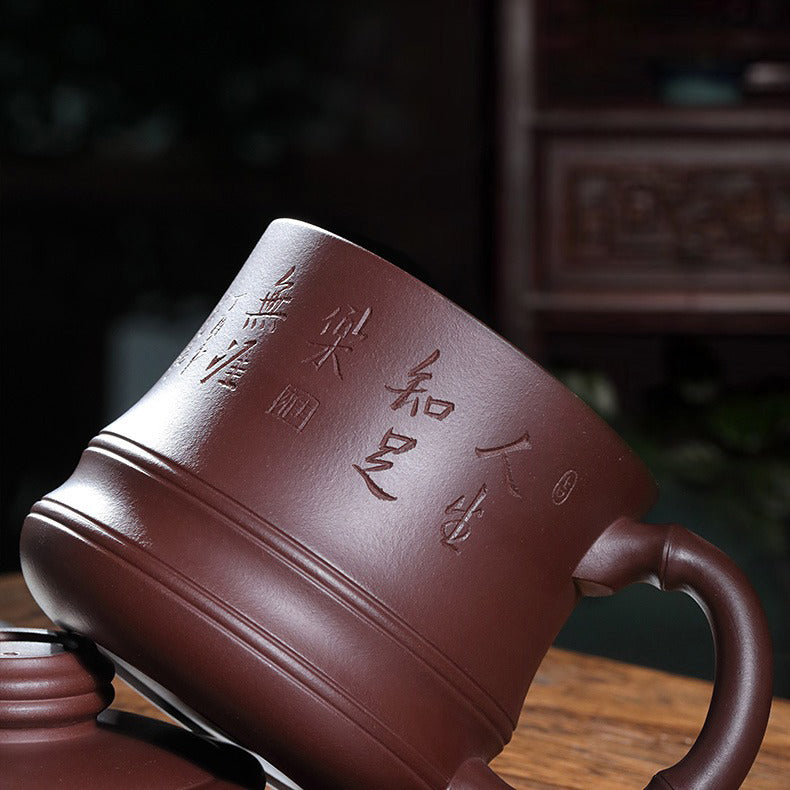 Close-up of purple clay bamboo teacup with infuser showing intricate carvings