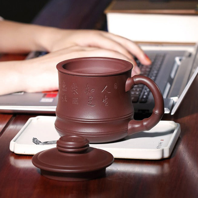 Elegant purple clay teacup in use, highlighting its heat resistance and craftsmanship