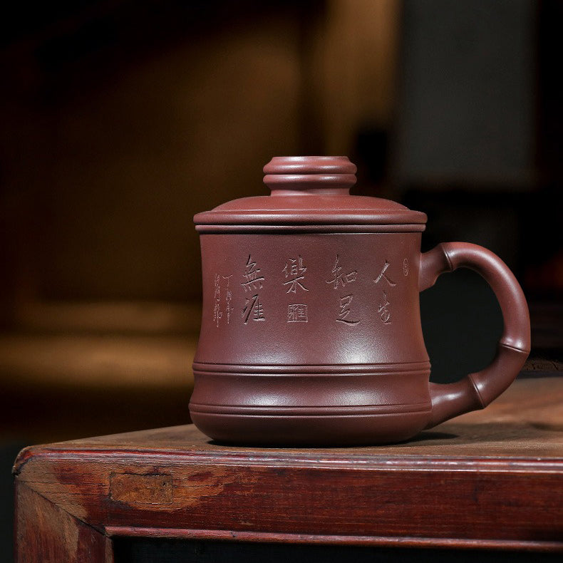 Elegant purple clay teacup in use, highlighting its heat resistance and craftsmanship