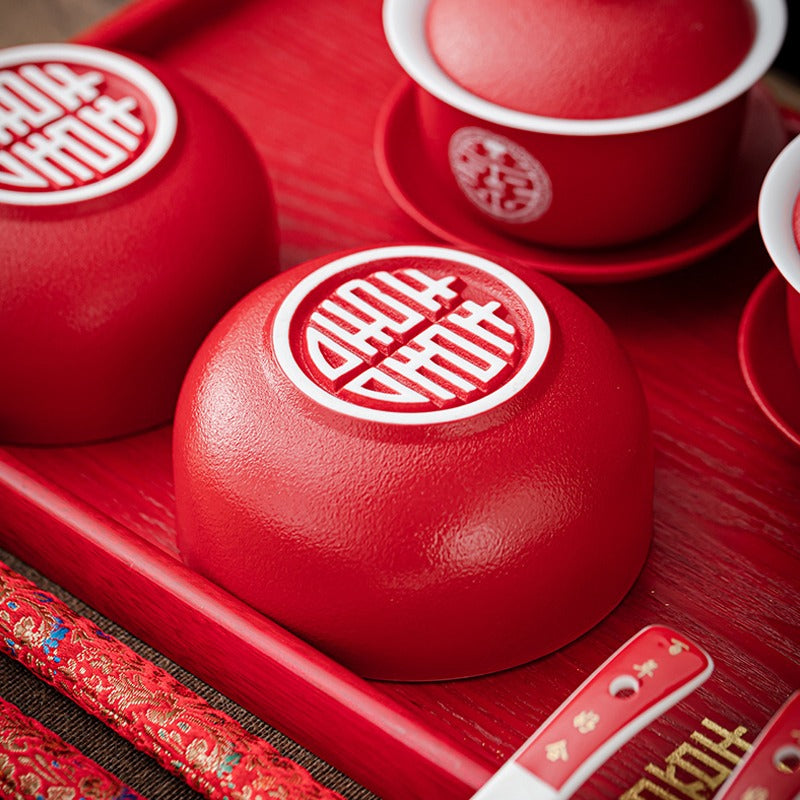 Close-up of the ceramic wedding tea set with double happiness design, showcasing gaiwans and bowls.