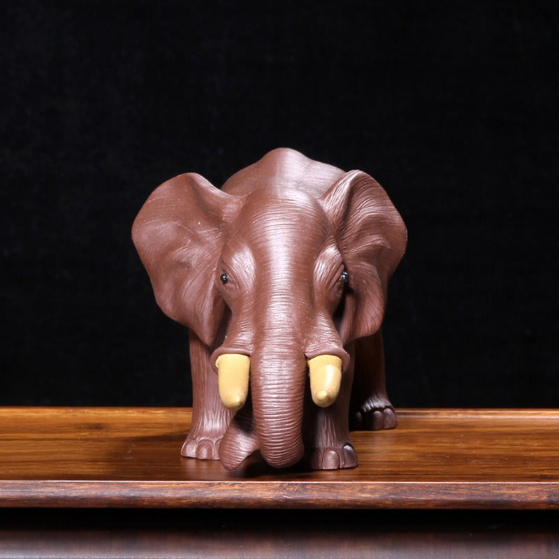 Close-up of Yixing elephant tea pet absorbing tea essence.
