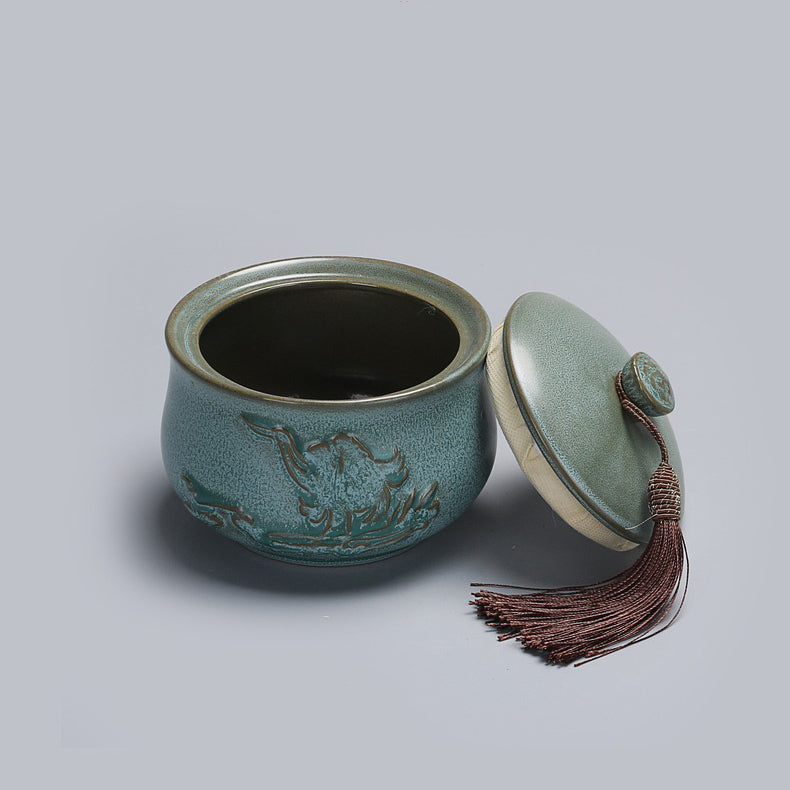 The blue pottery tea caddy displayed in a cozy kitchen setting, emphasizing its use for loose leaf tea storage.