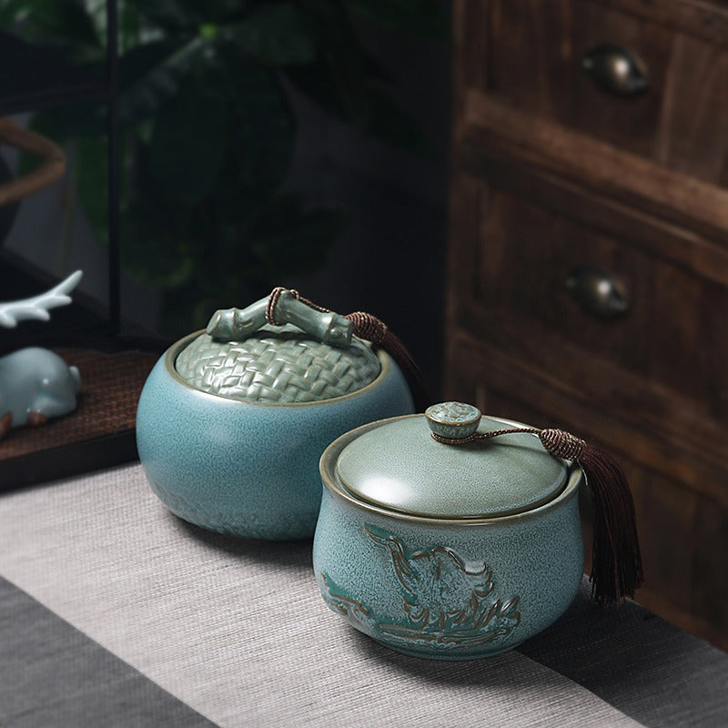 An open ceramic tea caddy filled with loose leaf tea, demonstrating its capacity and airtight seal.
