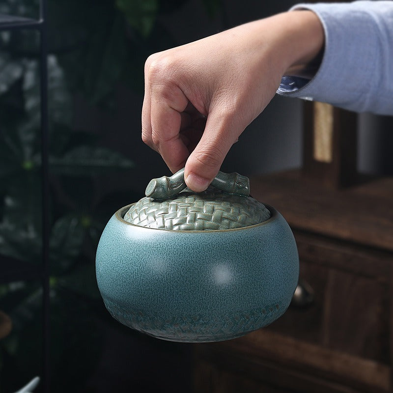 A close-up view of the ceramic blue pottery tea caddy, showcasing its unique texture and color.