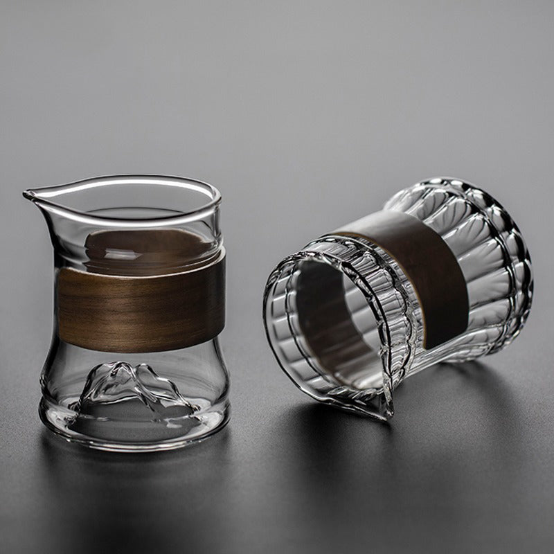 Close-up of the giant striped glass tea mug with bamboo handle, showing its detailed design and size.