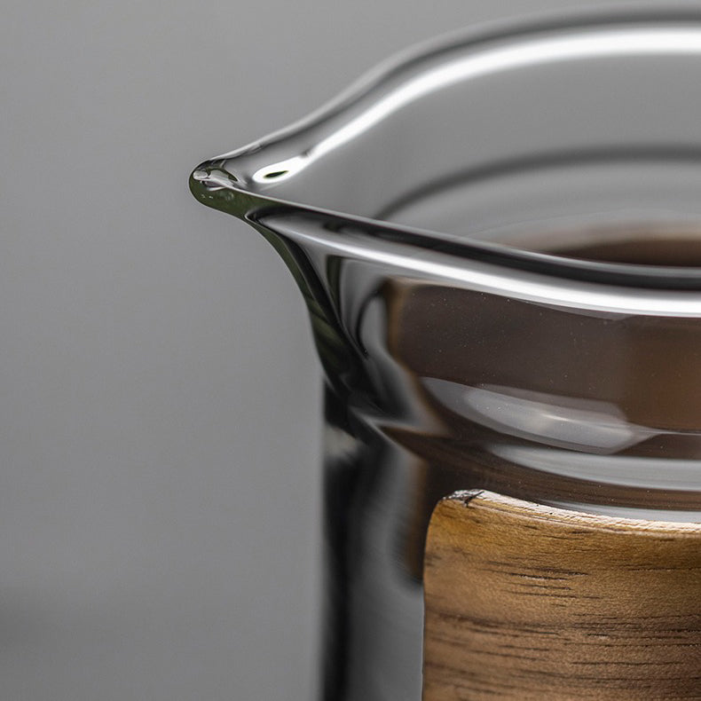 Stylish large glass tea cup with bamboo handle, ideal for gift-giving or decorative display.