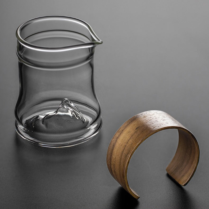 Close-up of the giant striped glass tea mug with bamboo handle, showing its detailed design and size.
