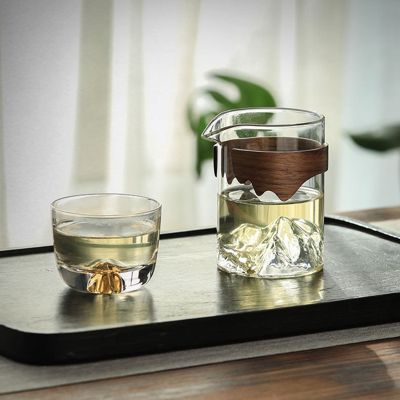 Stylish glass tea cup with bamboo handle displayed on a table