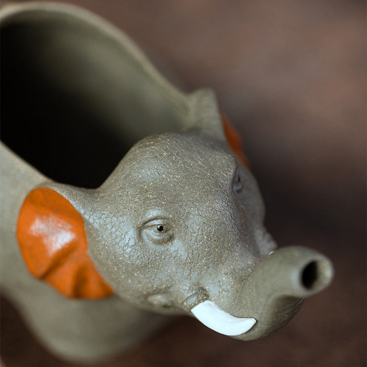 Decorative Yixing clay elephant tea cup on a tea table for display
