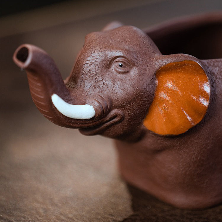 Close-up of handmade Yixing clay elephant tea cup showing detailed elephant design