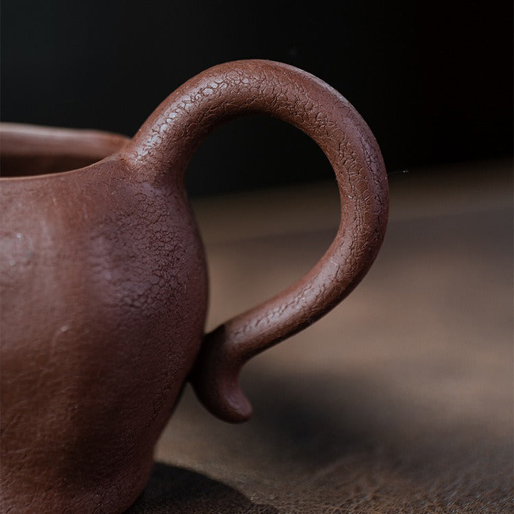 Large purple clay fair cup filled with tea, ideal for gongfu tea ceremonies
