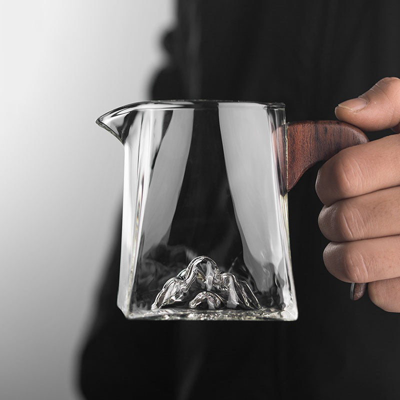 Large glass tea cup with wooden handle from a top view, ideal for daily tea brewing