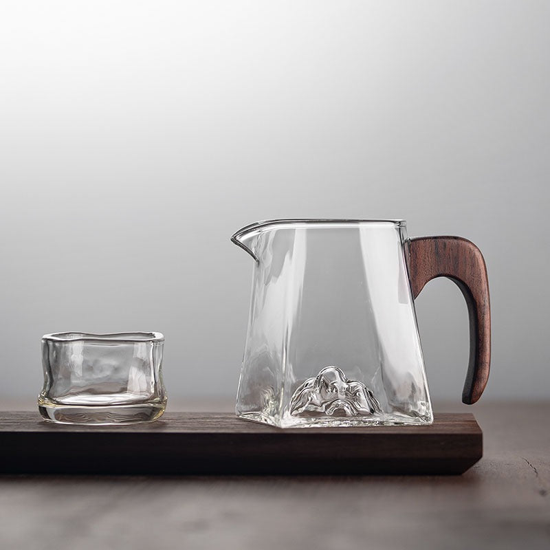 Side angle of the glass cup showing its spacious interior and sturdy wooden handle