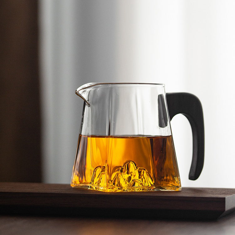 Large glass tea cup with wooden handle from a top view, ideal for daily tea brewing