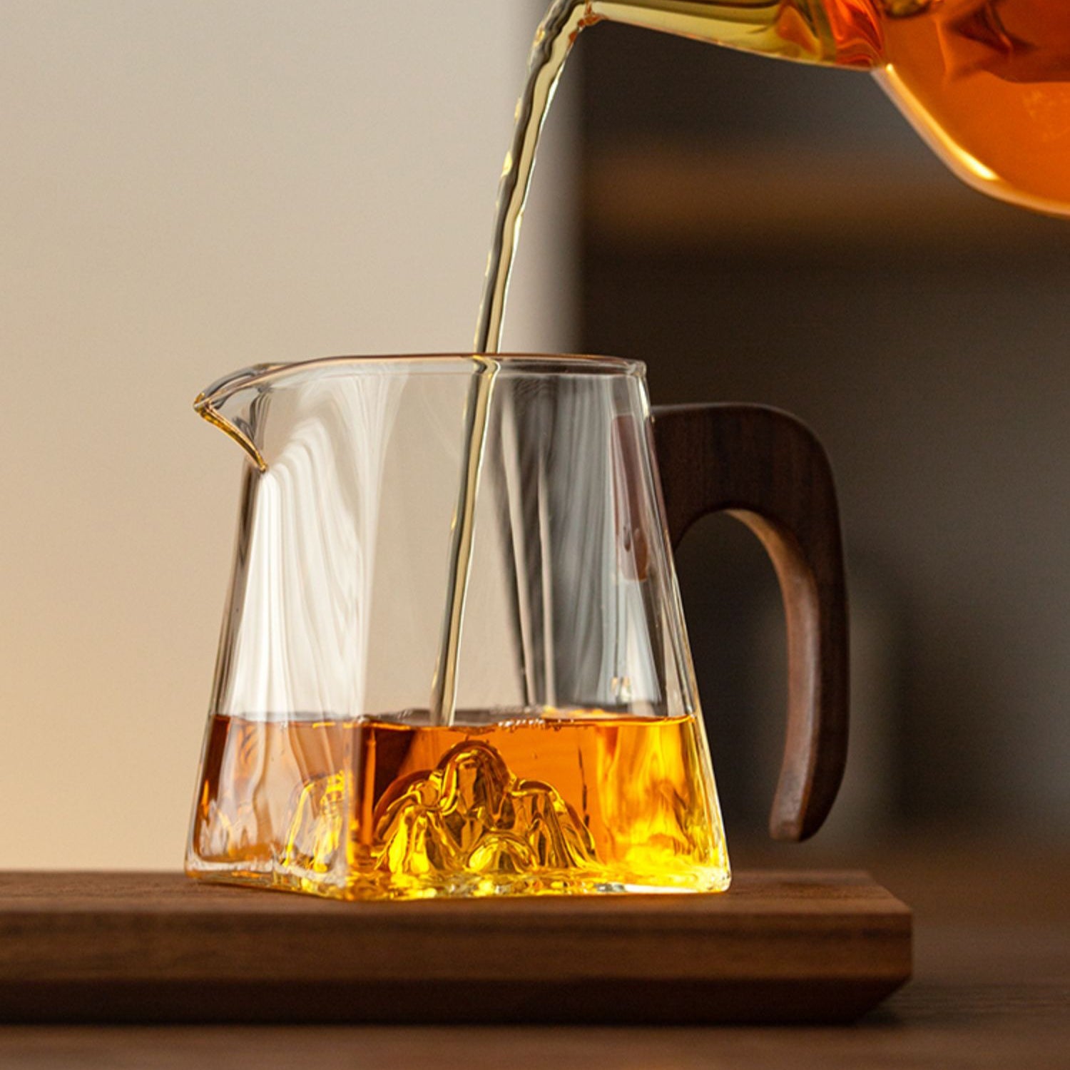Side angle of the glass cup showing its spacious interior and sturdy wooden handle