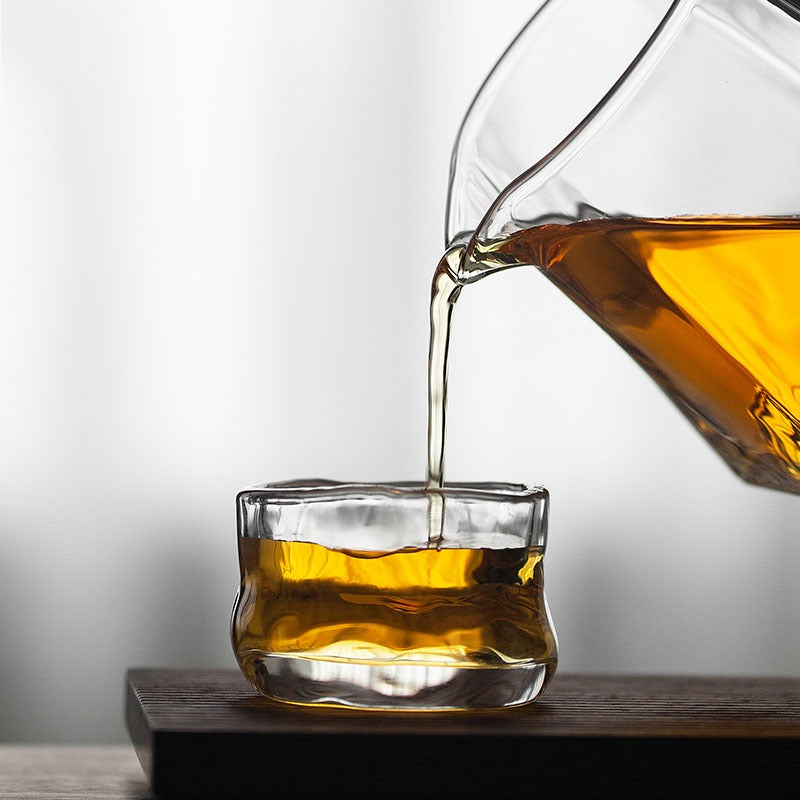 Decorative shot of the large glass tea cup filled with tea, highlighting its size and design