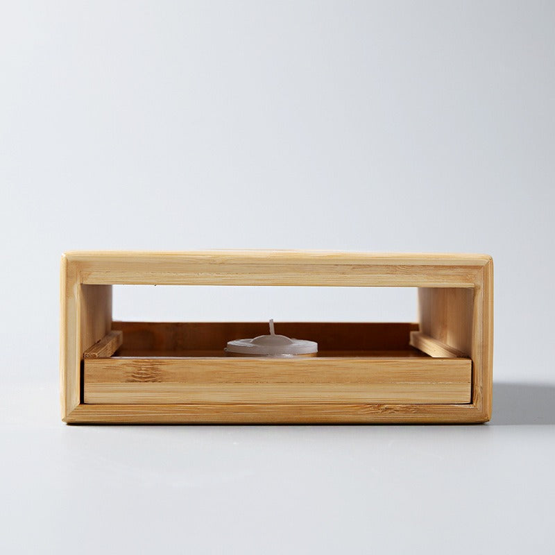 Stylish bamboo tea warmer with a lit candle, ideal for daily tea enjoyment