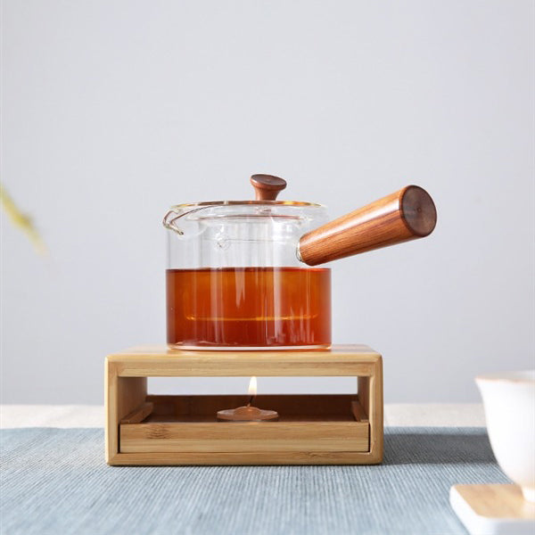 Stylish bamboo tea warmer with a lit candle, ideal for daily tea enjoyment