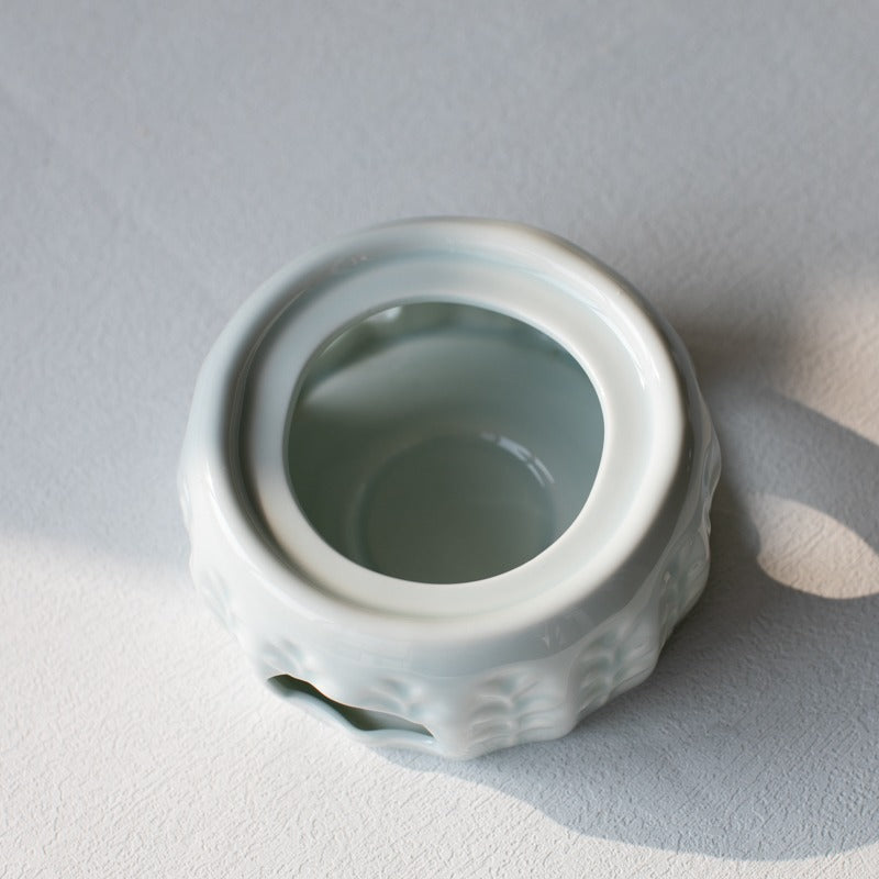 Top-down angle of candle teapot warmer in use with green tea