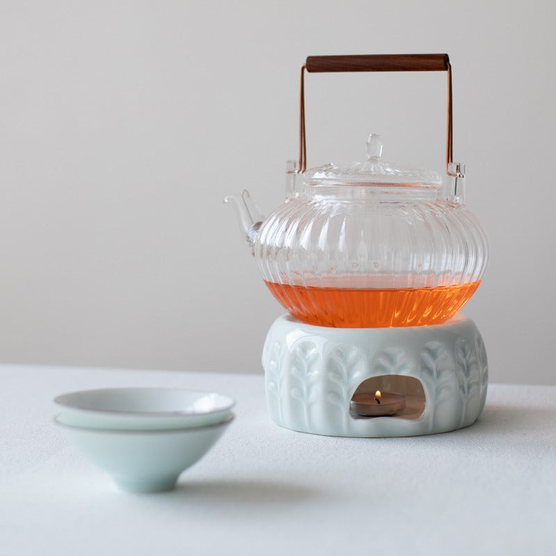 Top-down angle of candle teapot warmer in use with green tea