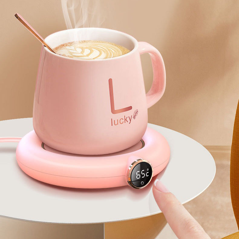 USB teapot warmer in use on a desk, keeping tea hot during work