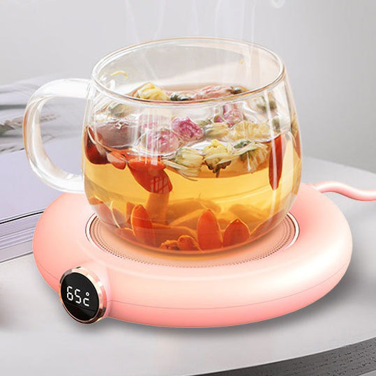 USB teapot warmer in use on a desk, keeping tea hot during work