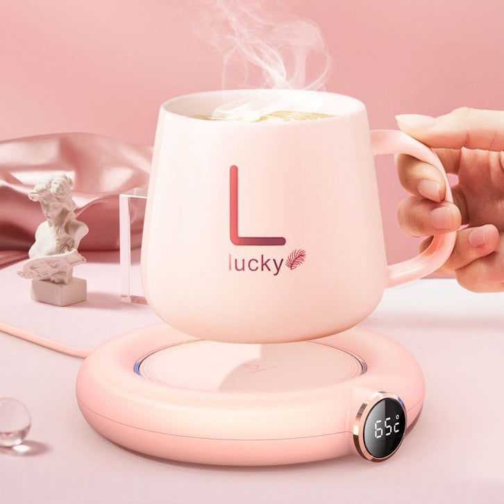 Close-up of ceramic USB teapot warmer with tea pot on top, stylish and modern design
