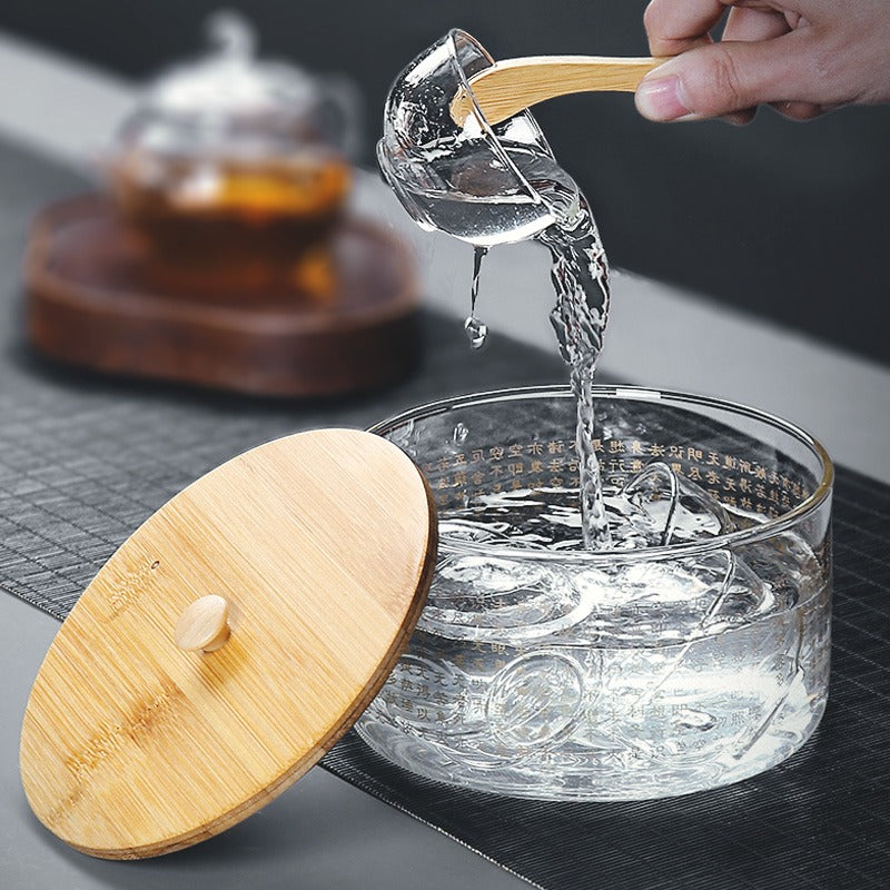 Glass tea infuser in use, demonstrating the process of cleaning tea cups.