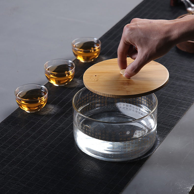 Glass tea infuser in use, demonstrating the process of cleaning tea cups.