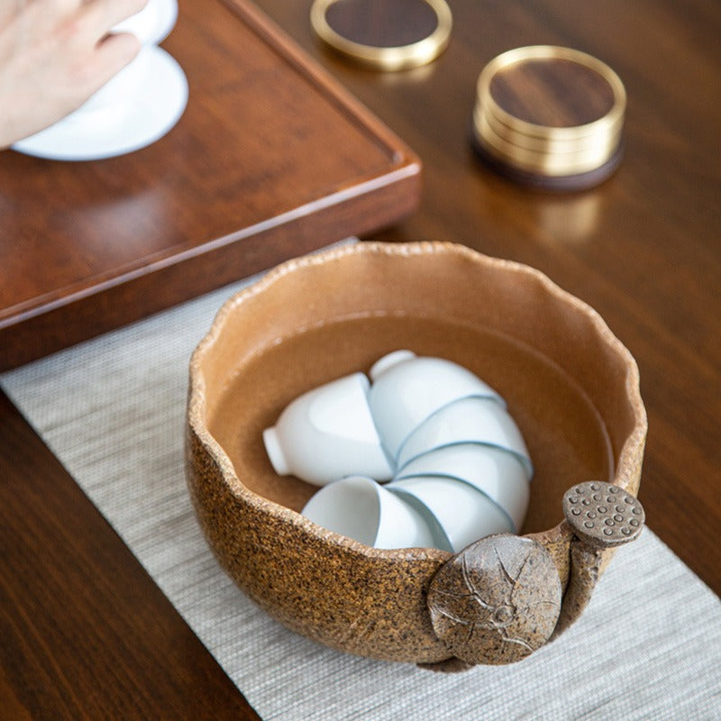 Close-up of the Artisan Coarse Pottery Lotus Tea Washer filled with boiling water