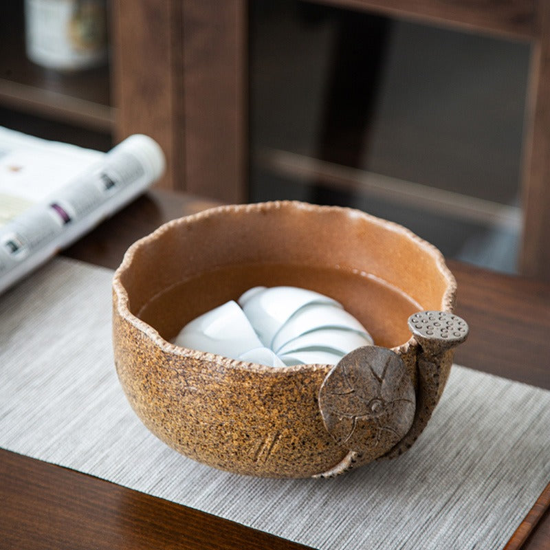 Close-up of the Artisan Coarse Pottery Lotus Tea Washer filled with boiling water